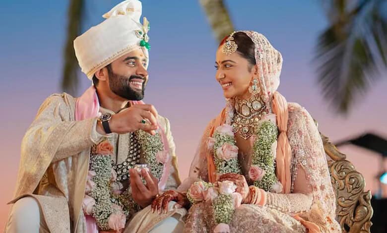 Wedding couple in traditional attire celebrating outdoors at sunset.