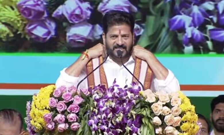 The image shows Telangana CM A Revanth Reddy speaking at a public meeting held in Pipri village of Adilabad district on Monday, April 6, 2026.