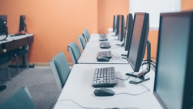 Computer lab with multiple desktops for exam preparation.