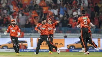 CSK players celebrating a wicket or victory in a cricket match.