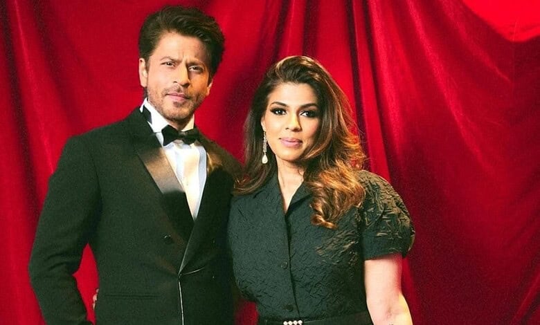 SRK’s manager with a woman at a red curtain event, highlighting Mumbai real estate investment.