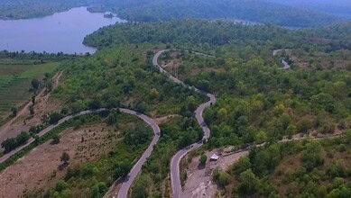 Aerial view of lush green hills and winding roads in the Kashmir of Telangana, offering a cool escape fro.