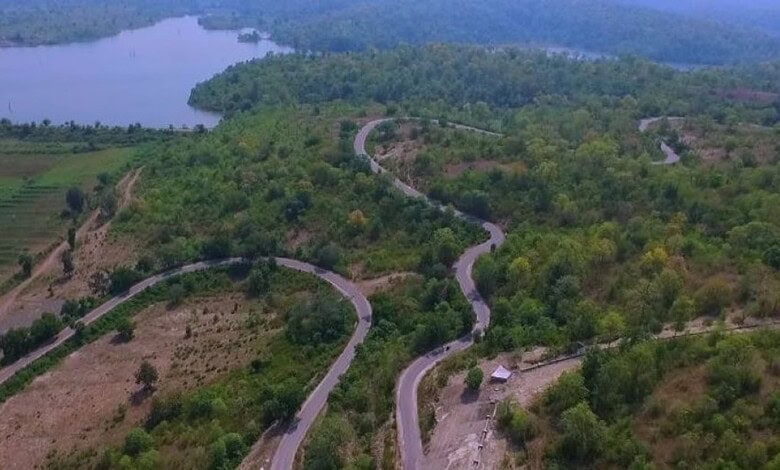 Aerial view of lush green hills and winding roads in the Kashmir of Telangana, offering a cool escape fro.