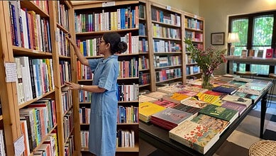 Women selecting books in a Hyderabad library, highlighting women's interest in reading.