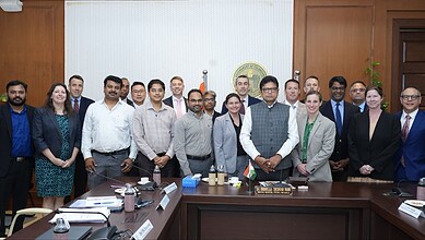 Group of officials and business leaders at a formal meeting in Telangana discussing aerospace sector inve.