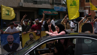 Supporters wave Hezbollah flags and make victory signs as they celebrate in the southern village of Zefta, Lebanon, Friday, April 17, 2026, following a ceasefire between Israel and Hezbollah.