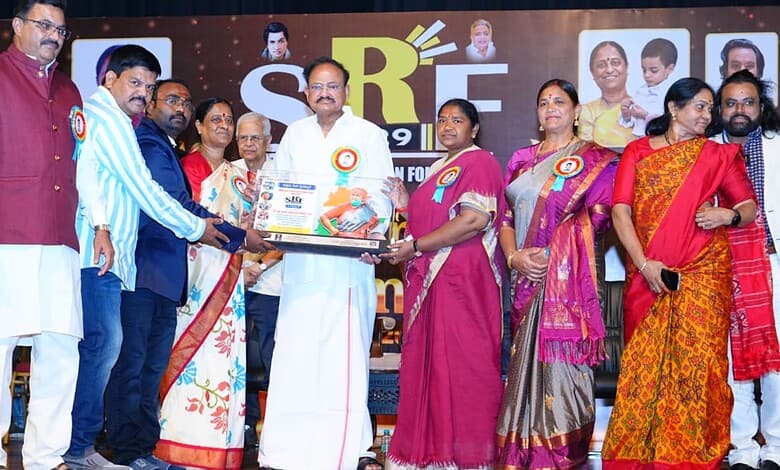 Telangana minister Seethakka receiving Best Service Award from former VP Naidu at an event.