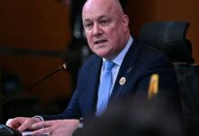 New Zealand PM Christopher Luxon addresses a meeting