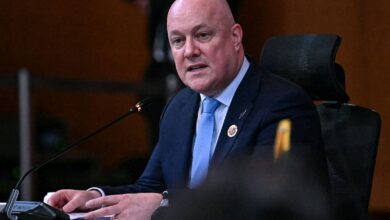 New Zealand PM Christopher Luxon addresses a meeting