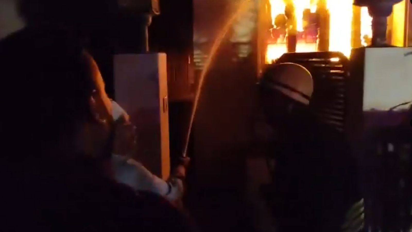 Firefighters douse the fire at Red Hills