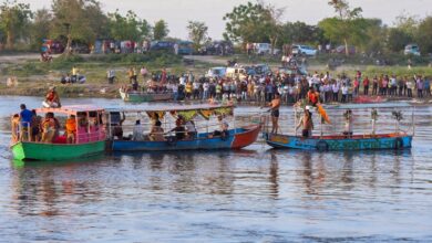 Devotees take a boat ride on the Yamuna