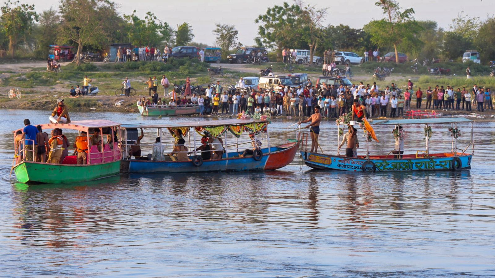 Devotees take a boat ride on the Yamuna