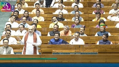 Prime Minister Modi speaking in Parliament with members listening attentively.