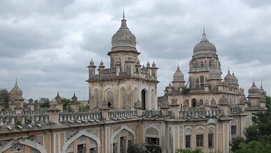 Osmania Hospital building in Hyderabad under cloudy sky.