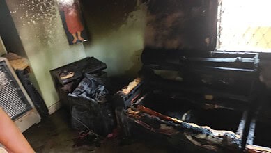 Fire damage to a sofa after a tragic incident during puja at Begumpet.