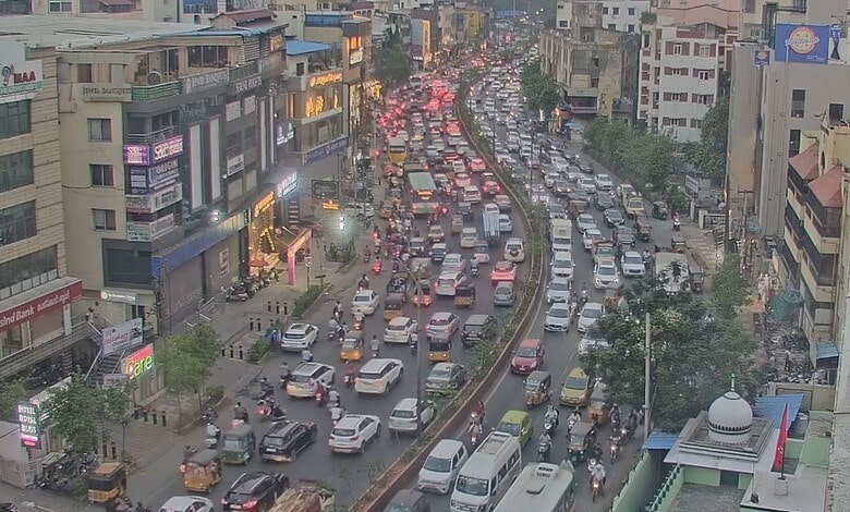 City traffic jam with numerous vehicles on crowded city street.