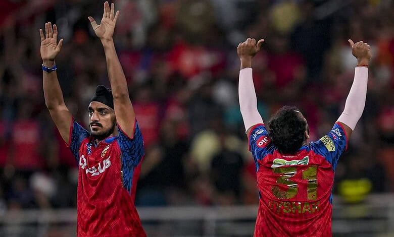 Players celebrating cricket match success with raised hands.
