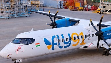 Flydubai plane parked on the tarmac amid airport equipment and cargo.