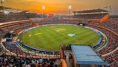 Cricket stadium filled with spectators at sunset, preparing for IPL 2026 matches.