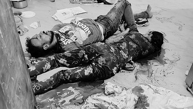 Man and woman injured on the floor following a violent incident in Telangana.