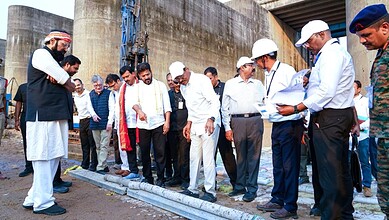 Group of politicians and officials discussing at the Kaleshwaram project site, highlighting political ten.