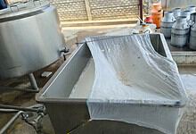 Food adulteration testing with a metal sieve and chemicals in a laboratory setting.