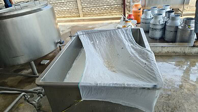 Food adulteration testing with a metal sieve and chemicals in a laboratory setting.