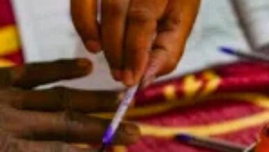 An image showing a person lighting a traditional lamp during a political event in West Bengal, highlighti.