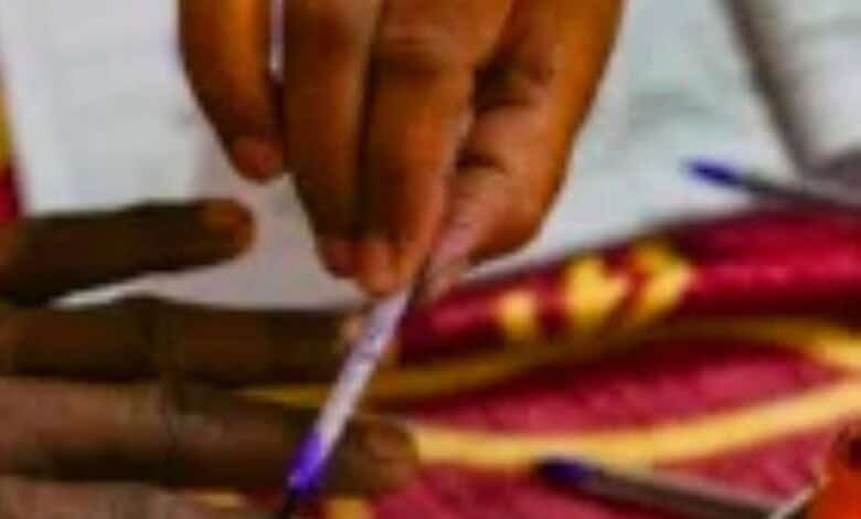 An image showing a person lighting a traditional lamp during a political event in West Bengal, highlighti.