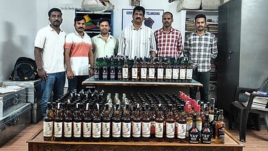 Telangana excise officials with the seized liquor