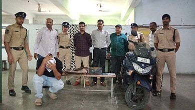 Police officers and officials with seized motorcycle and items at a crime scene.
