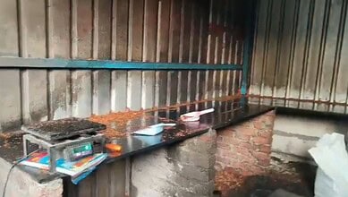 Empty kitchen countertop with cooking utensils and supplies in a rustic setting.