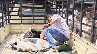 Man lying unconscious at ATM in Hyderabad, surrounded by onlookers, after being found dead.