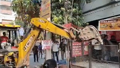 A fence on a footpath is being demolished