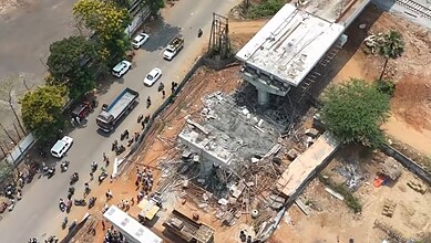 Collapsed under-construction bridge in Visakhapatnam with injured people and debris.