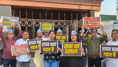 Protesters holding signs in Hindi during Mumbai protest against Raghav Chadha, demonstrating political ac.