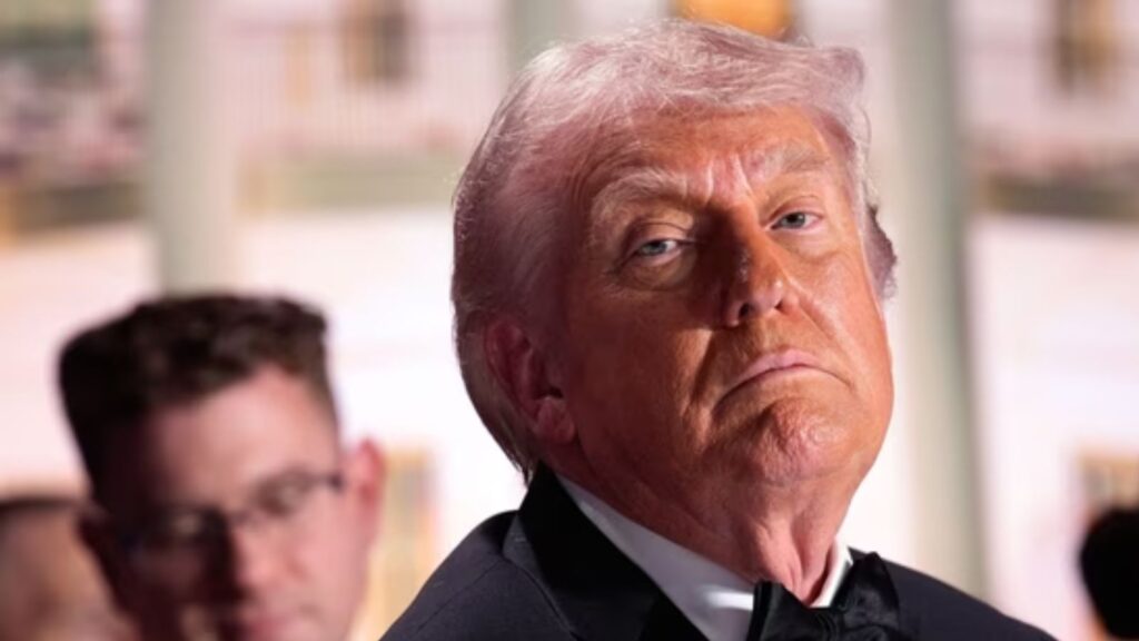 Image of Donald Trump with a serious expression, related to media dinner shooting suspect's statements.