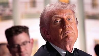 Image of Donald Trump with a serious expression, related to media dinner shooting suspect's statements.