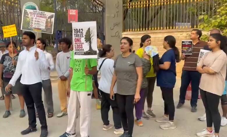 Protesters gather with signs advocating for climate change awareness and environmental protection during.