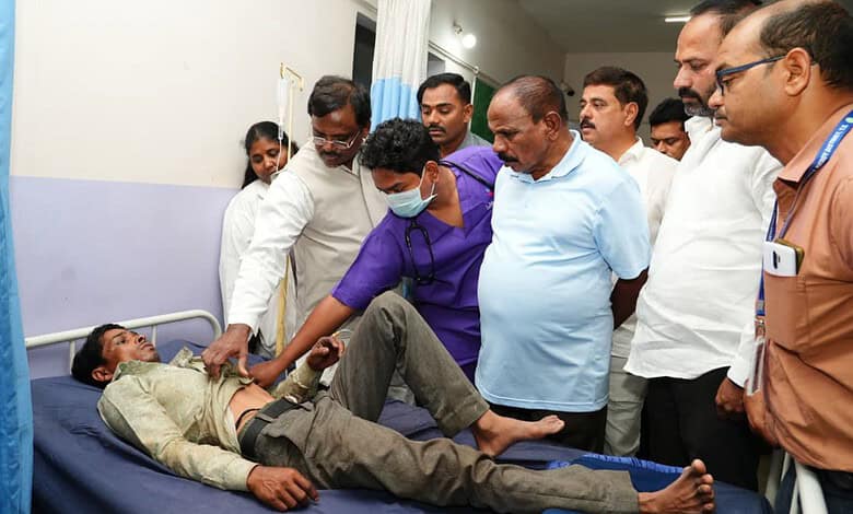 Telangana Minister inspecting victims of crane collapse in hospital with medical staff and officials.
