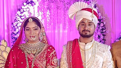 Sonam Raghuvanshi in wedding dress with her husband at a colourful Indian wedding.