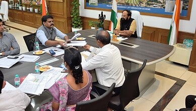 Telangana government officials discuss paddy procurement plans with Uttam Kumar in a meeting.