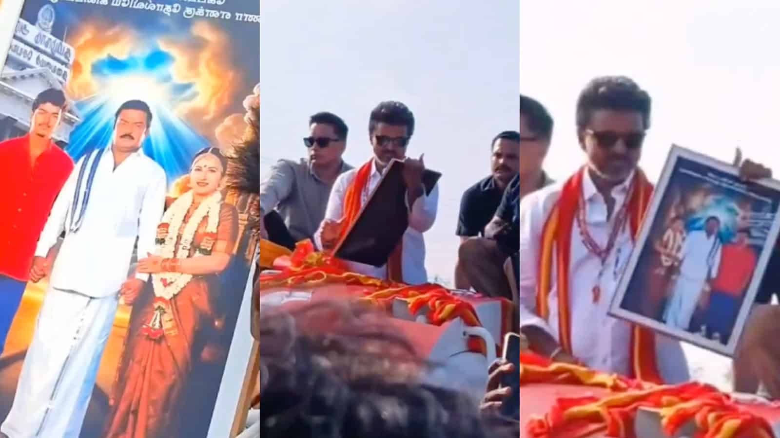 A man in traditional attire addresses a crowd, holding a framed picture, during a public event at Siasat.