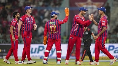 Shami and Mohsin celebrate on the field after a successful bowling effort in cricket match.
