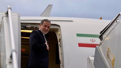 Businessman boarding an aircraft at the airport, ready for travel, with the Iranian flag visible on the p.