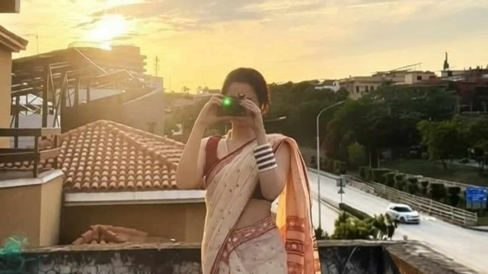 Pakistani actress taking a selfie outdoors, celebrating reaching 20 million followers on Instagram.