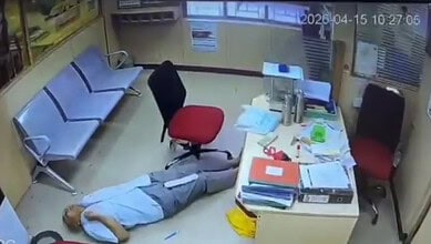 Man experiencing a heart attack collapses at a bank in Hyderabad, lying on the floor as staff and custome.