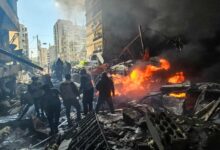 Emergency responders survey burning debris and damaged buildings after an Israeli airstrike in Beirut’s Corniche al-Mazraa area.
