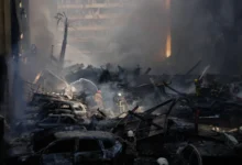 Firefighters battle flames amid heavy smoke after Israeli strikes in Beirut.