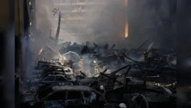 Firefighters battle flames amid heavy smoke after Israeli strikes in Beirut.